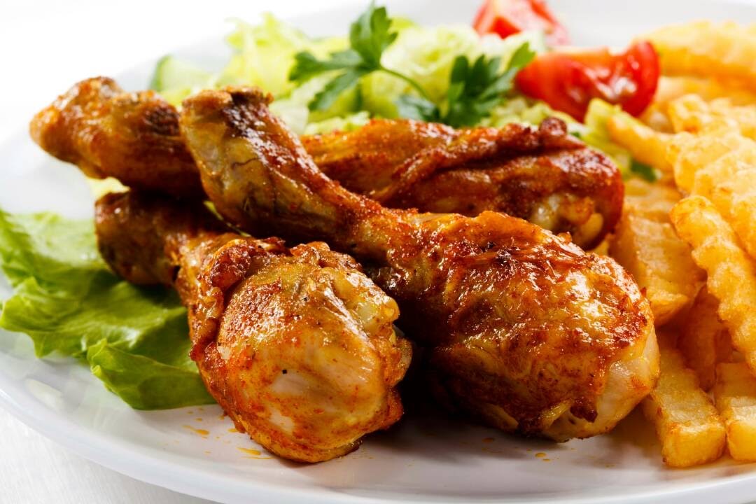 Golden chicken pieces served with chips and salad
